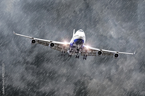 Large passenger airplane approaches the landing at the airport of rain, bad weather.