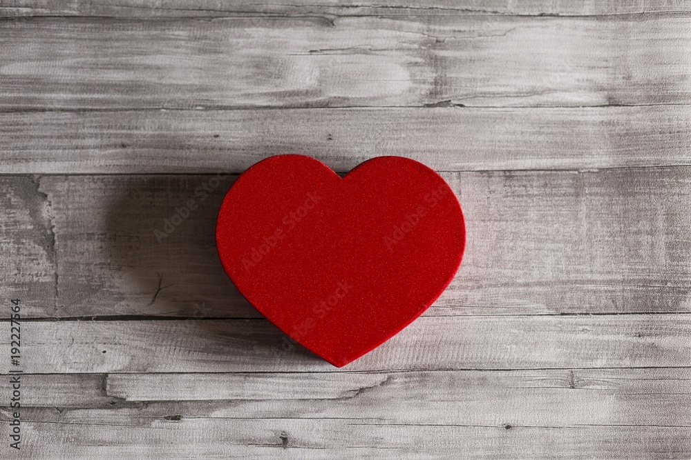 red heart over grey wood background, isolated. Valentines day concept