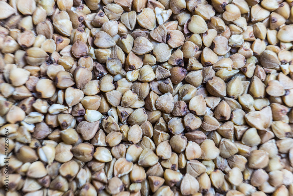 Buckwheat von. Raw buckwheat grains close-up. Macro background. Buckwheat von. Raw buckwheat grains close-up. Macro background.