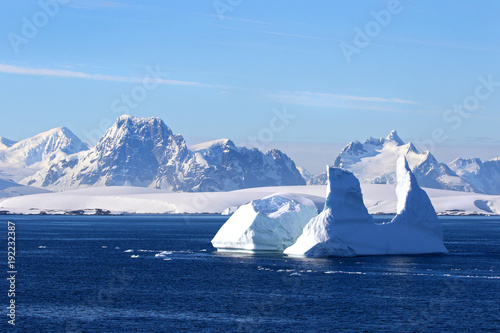 Antarctica on a Sunny day- Antarctic Peninsula - Huge Icebergs and blue sky.