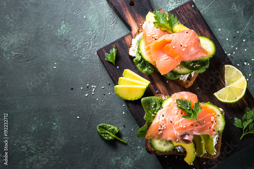 Open sandwich with salmon spinach and avocado.