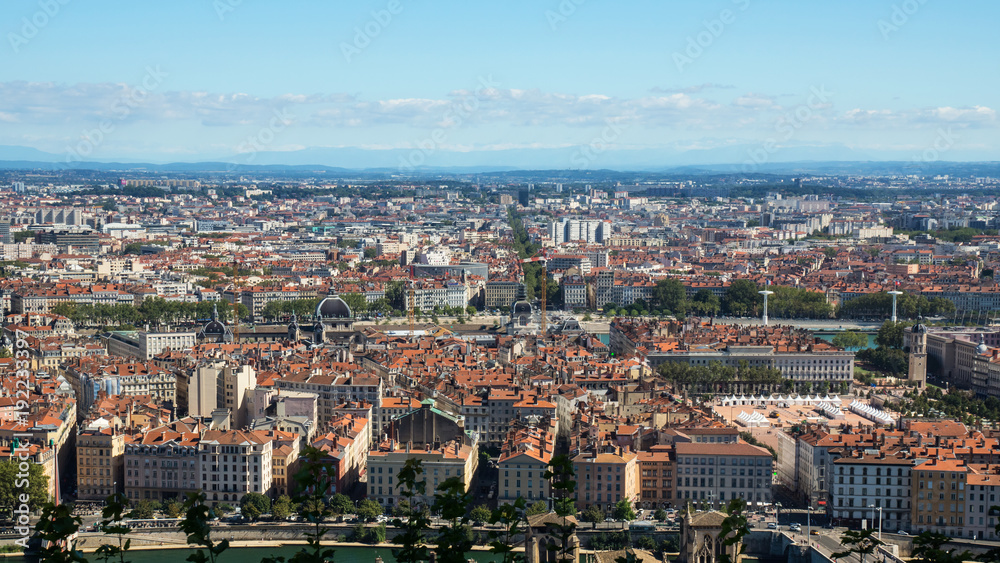 Panoramic view on Lyon city and red roofs from Fourviere hill during summer day.