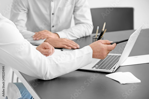 Male doctor consulting patient in clinic