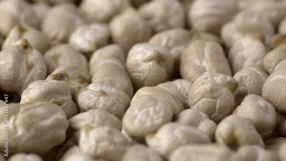 Raw chickpeas closeup macro revolving on a turntable. Shallow depth of field. Not loopable. Colors out of camera. No color grading. Raw chickpeas closeup macro revolving on a turntable. Shallow depth of field. Not loopable. Colors out of camera. No color grading.