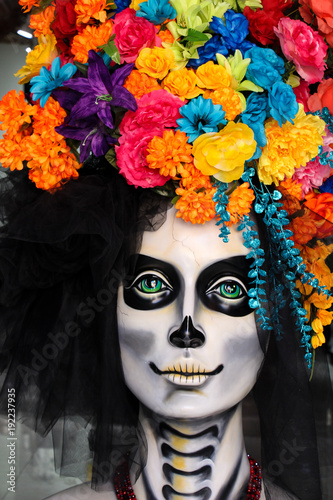 Lovely and colorful catrina with bright flowers up her head