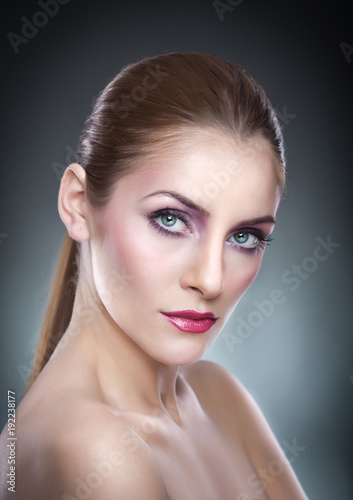 Professional make up - beautiful female art portrait with beautiful eyes. Elegance. Genuine natural woman in studio. Portrait of a attractive woman with red lips and creative make up 