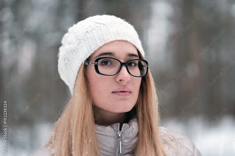 Portrait of a beautiful young lady on a winter forest background. Portrait of a beautiful young lady on a winter forest background.
