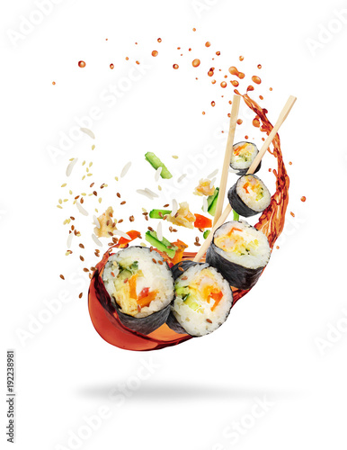 Pieces of sushi with splashes of soy sauce, isolated on white background