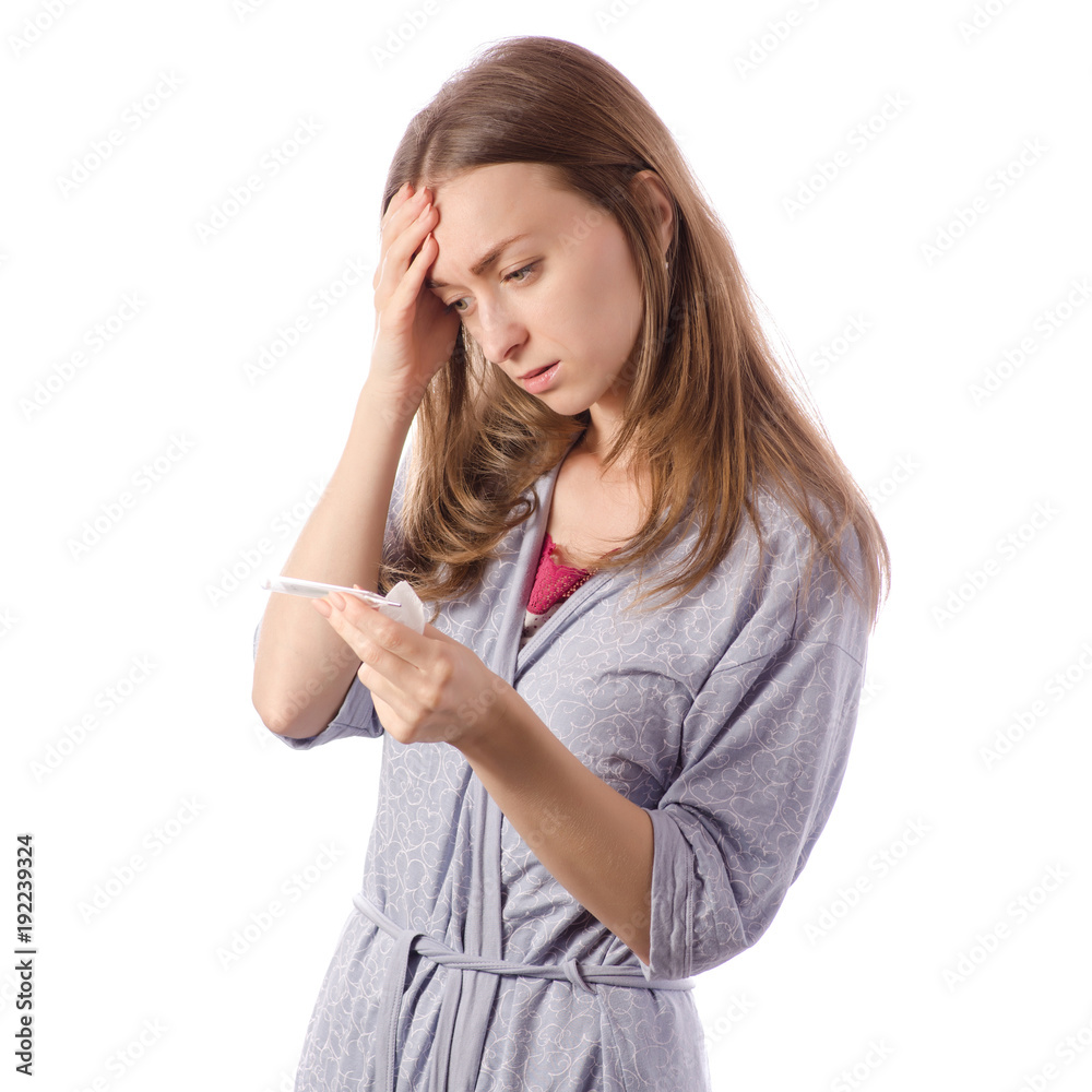 Young beautiful woman in a bathrobe measures the temperature of a cold flu illness napkins Young beautiful woman in a bathrobe measures the temperature of a cold flu illness napkins