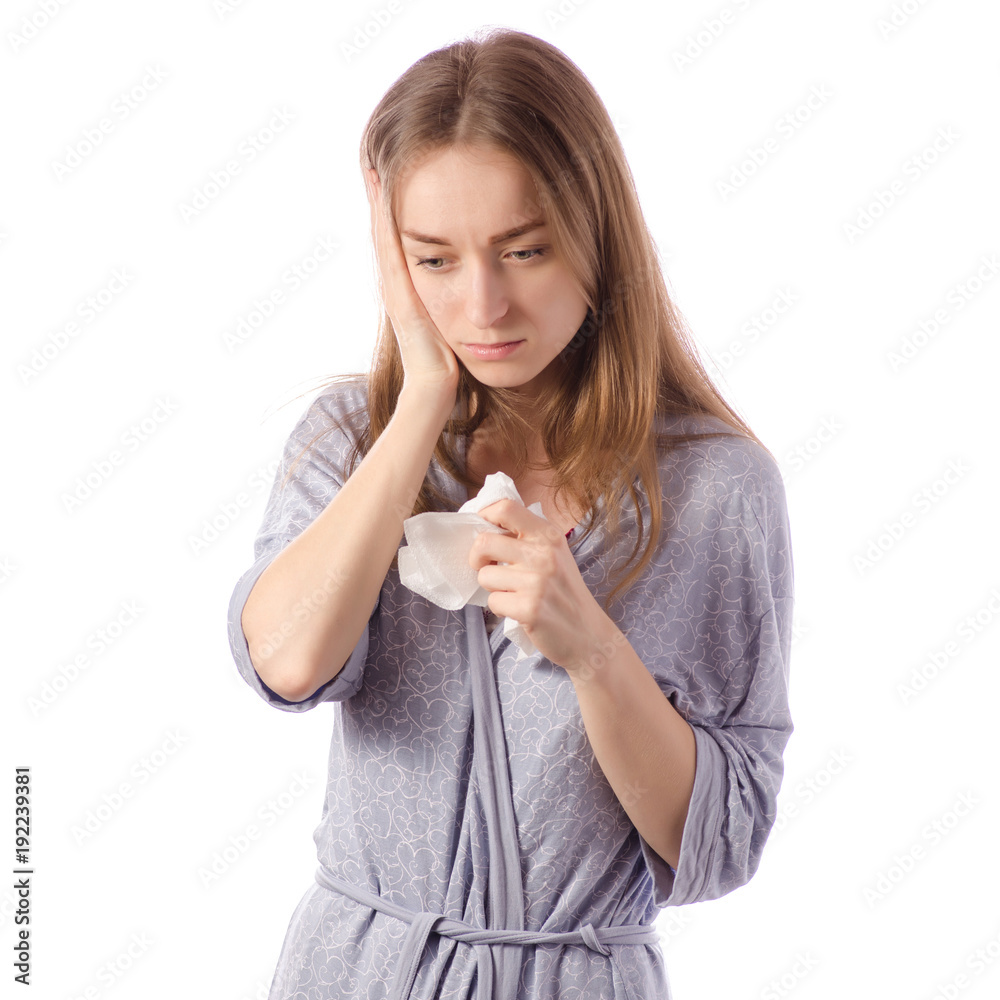 Young beautiful woman in a bathrobe has a headache cold flu napkin Young beautiful woman in a bathrobe has a headache cold flu napkin