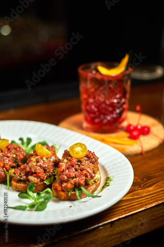 bruschetta, on slices of toasted baguette garnished with basil