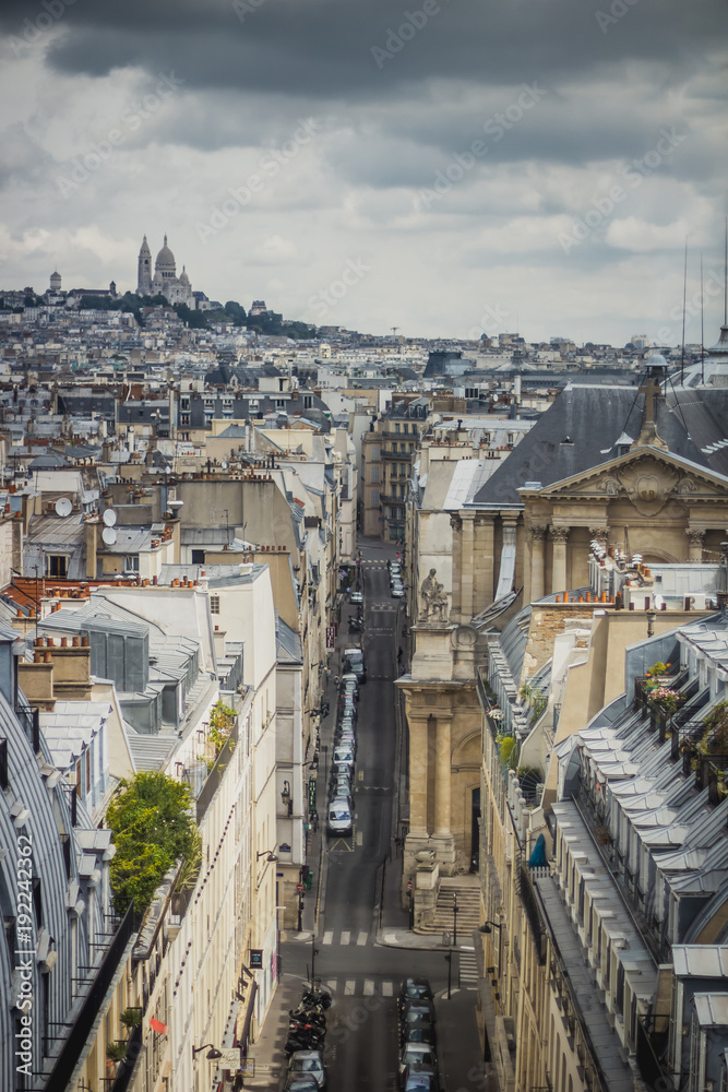 View of Paris, Rue Saint-Roch with Sacre Coeur basilica in the background View of Paris, Rue Saint-Roch with Sacre Coeur basilica in the background