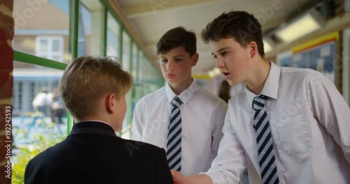4K Young boy at school being bullied by older boys