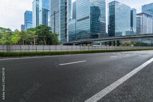 Empty urban road and modern skyline. © hallojulie