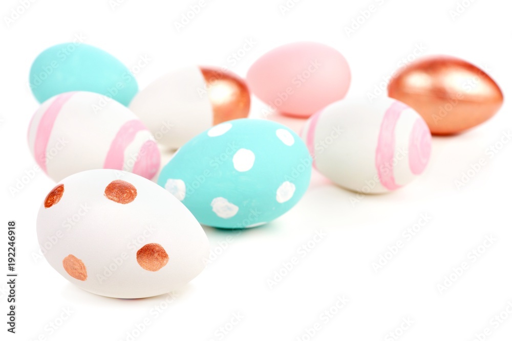 Easter border or background of turquoise, pink, white and rose gold eggs over white