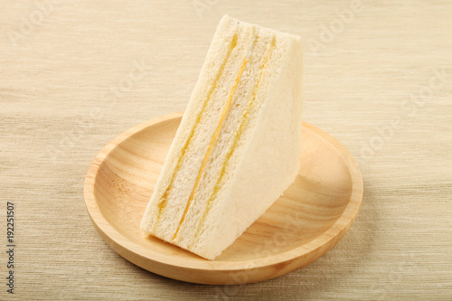 Orange butter cheese sandwich  on a wooden  plate 