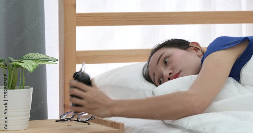 Pretty asian woman refusing to wake up lying on her bed Pretty asian woman refusing to wake up lying on her bed