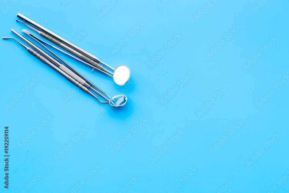 Fototapeta premium Dentist tools. Teethcare, dental health concept. Blue background top view copy space