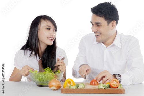 Asian couple preparing salad
