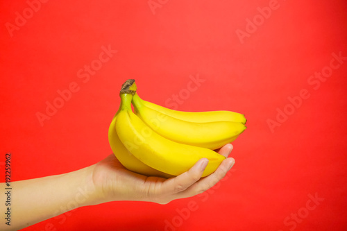 banana and hand. バナナを手にもつ 赤色背景