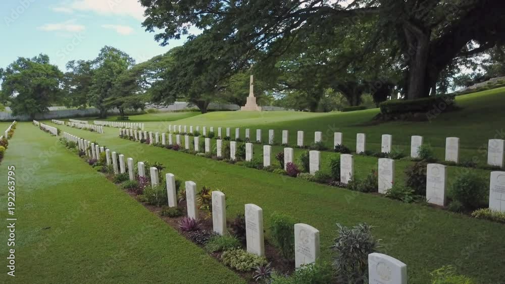 A birds eye view shot of a tombstone and trees. Camera moves forward A birds eye view shot of a tombstone and trees. Camera moves forward