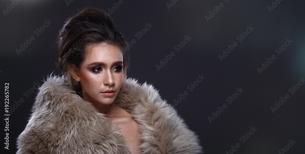 Woman looking an idea and pointing to left side copy space Woman looking an idea and pointing to left side copy space