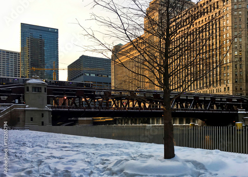 Wallpaper Mural Elevated "el" train passes over the Chicago River and a snow covered Riverwalk in winter. Torontodigital.ca