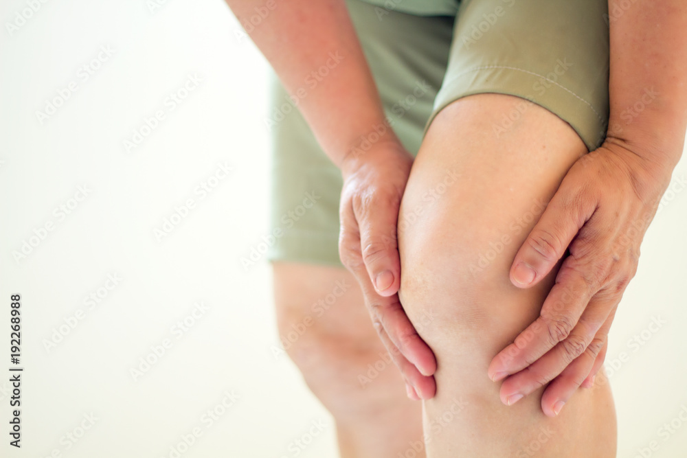 Soft focus of Old Asian women to knee injury on white background
