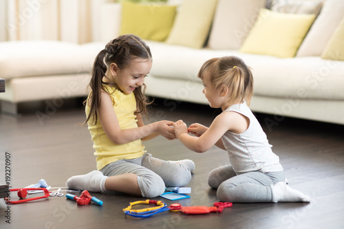 Child girl playing doctor w...