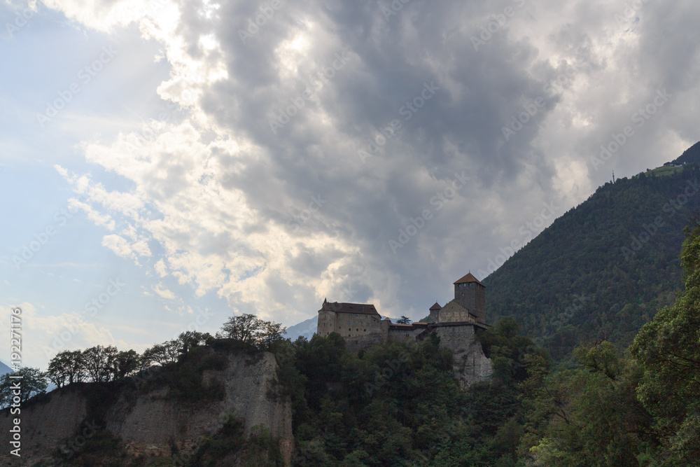 Tyrol Castle, dark storm clouds and mountain panorama in Tirol, South Tyrol