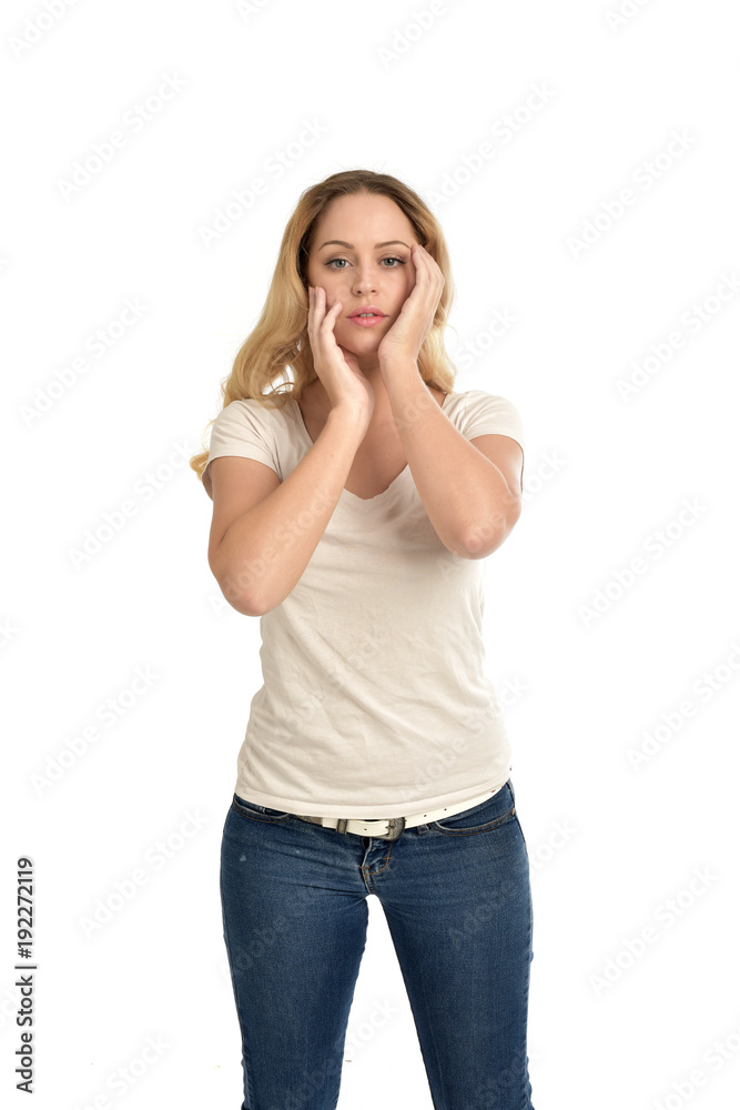 3/4 portrait of blonde girl wearing white shirt, posing with hands touching body. isolated on white background. 3/4 portrait of blonde girl wearing white shirt, posing with hands touching body. isolated on white background.