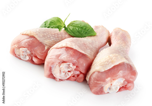 Raw chicken legs and basil isolated on white background.