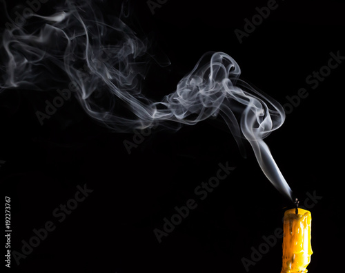 Yellow Candle with white smoke on black background