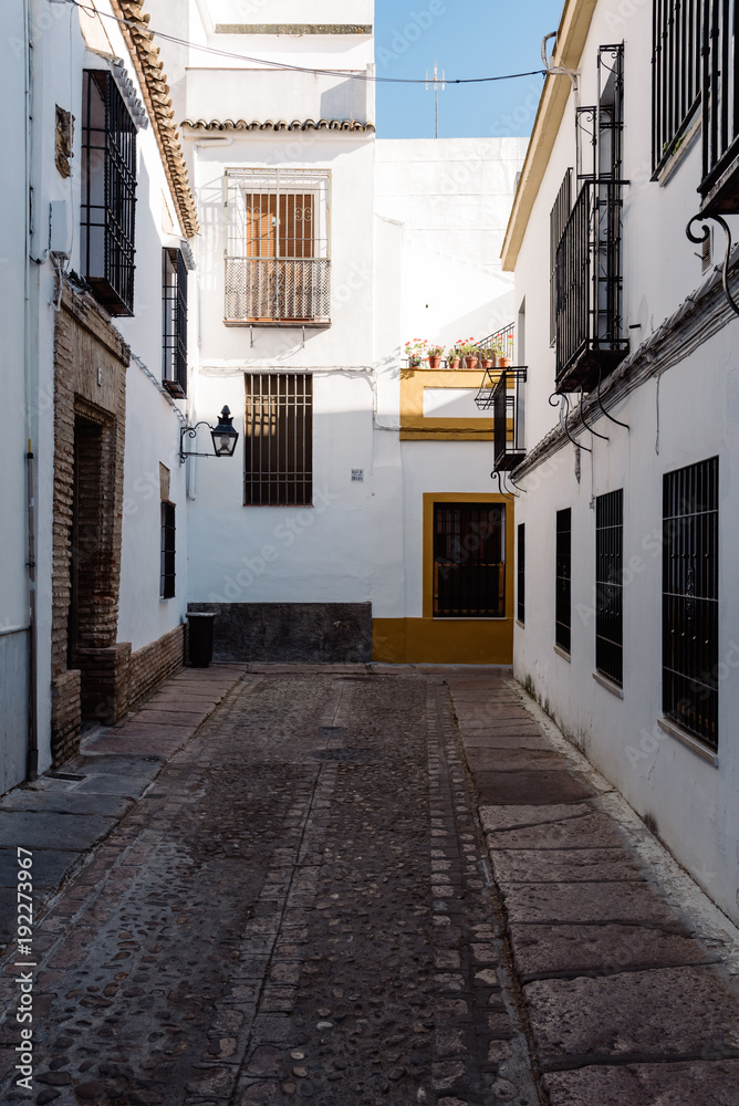 Old typical narrow street in the jewish quarter of Cordoba with