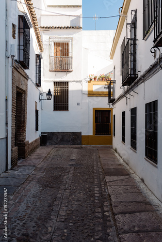 Old typical narrow street in the jewish quarter of Cordoba with © jjfarq