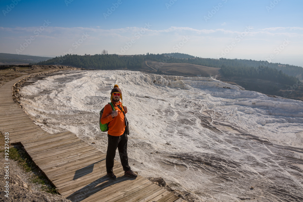 Obraz premium Woman walking on the terraces at Pamukkale. It cotton castle in Turkish and is natural site