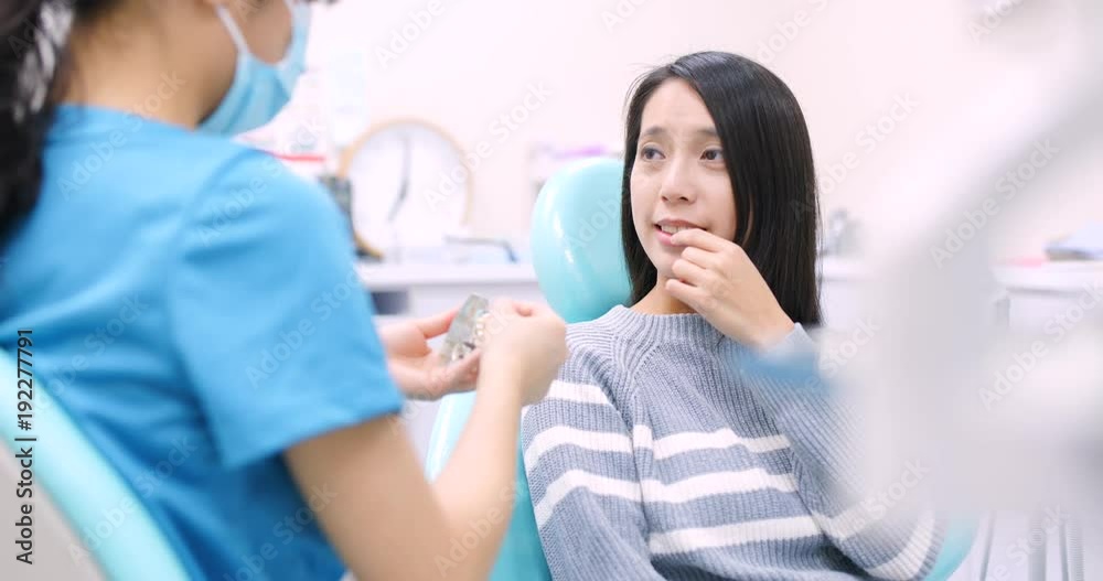 Woman undergo consultation with dentist at dental clinic Woman undergo consultation with dentist at dental clinic