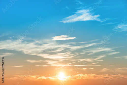Fototapeta Naklejka Na Ścianę i Meble -  Sunset in the sky with blue orange clouds and big sun