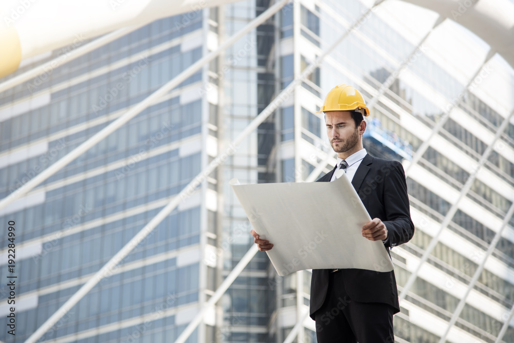 business engineer hand holding construction drawing. concept consulting planning for engineering.