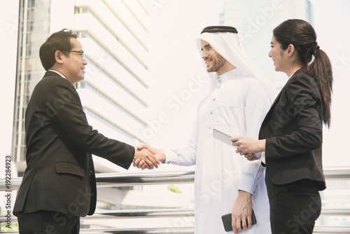 businessman arabic with engineer making handshake agreement. concept finishing up a meeting.