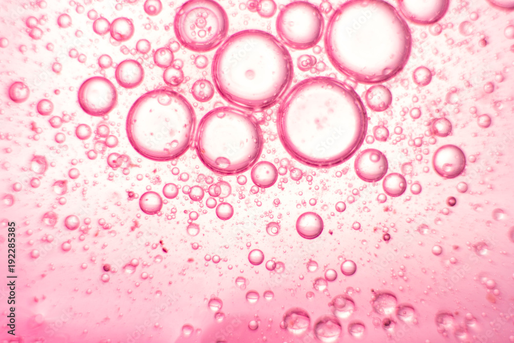 Pink oil bubbles on water surface Pink oil bubbles on water surface