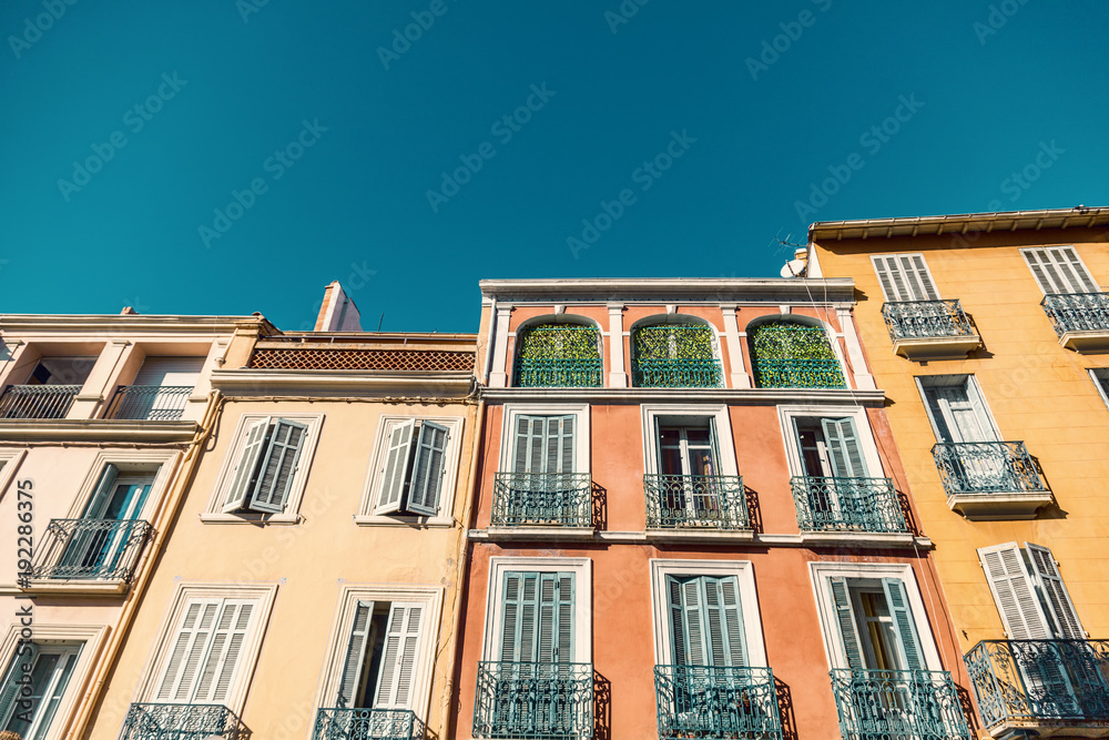 Bright colorful facades of ancient buildings, Provence, Côte d'Azur, France, Fréjus. Typical French architecture, shutters, carved delicate details
