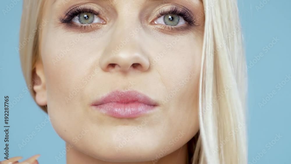 Attractive and adult woman touching her face 