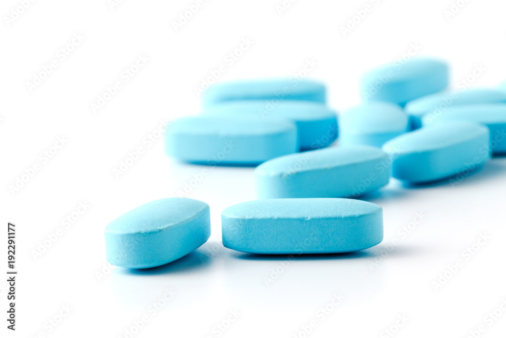 Pile of blue pills isolated on white