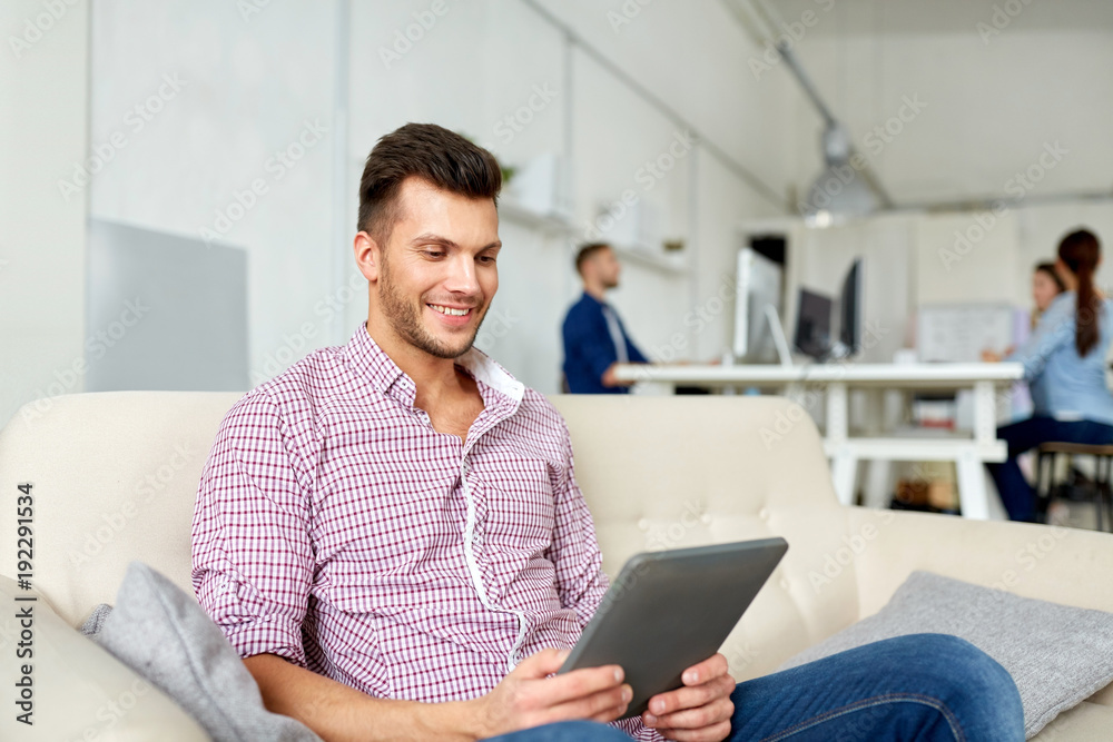 man in glasses with tablet pc working at office man in glasses with tablet pc working at office