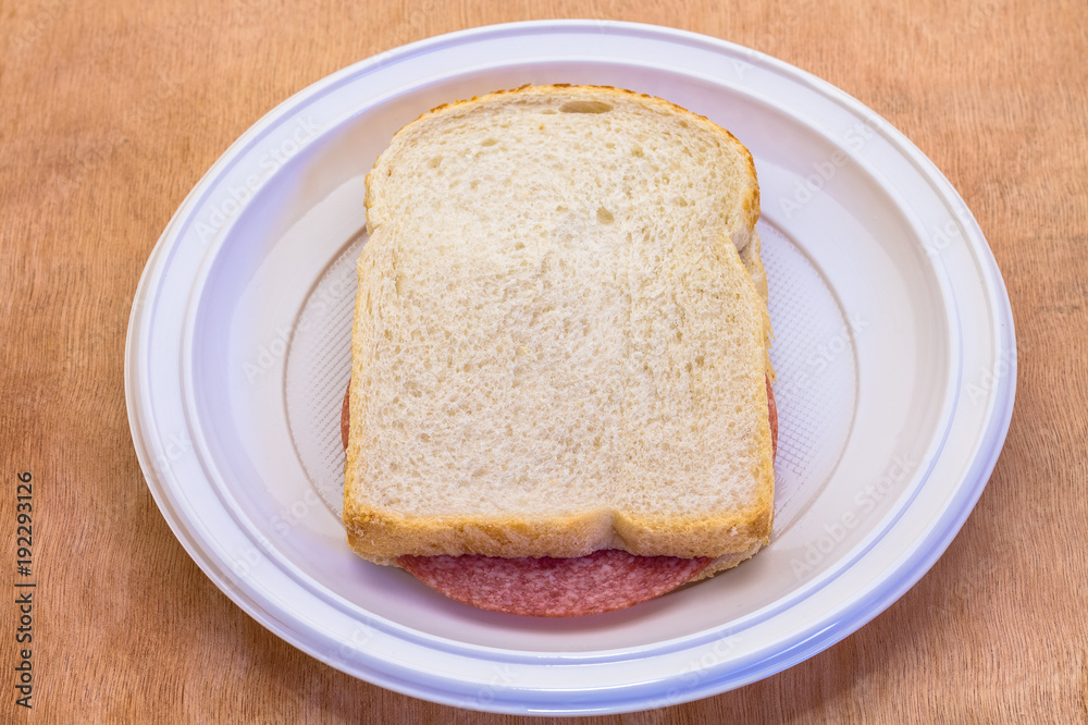 sandwich white bread with slice of sausage meat on white plate sandwich white bread with slice of sausage meat on white plate