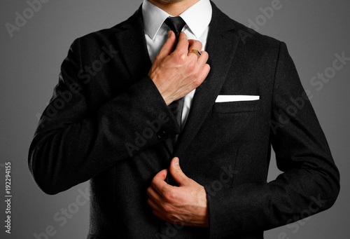 Businessman in a black suit, white shirt and tie. Studio shooting