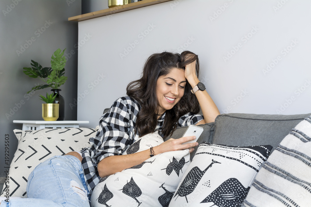 Portrait of Beautiful Smiling Woman Using Mobile Phone at Home Portrait of Beautiful Smiling Woman Using Mobile Phone at Home