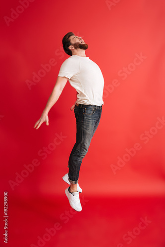Excited bearded man levitate isolated
