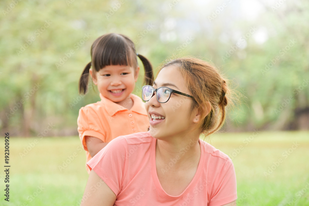 Asian mother and her daughter smiling together. Asian mother and her daughter smiling together.